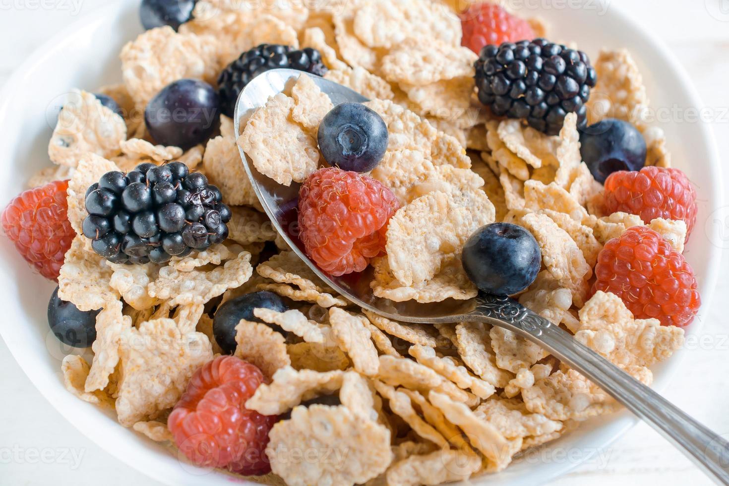 Corn flakes and berry fruits photo
