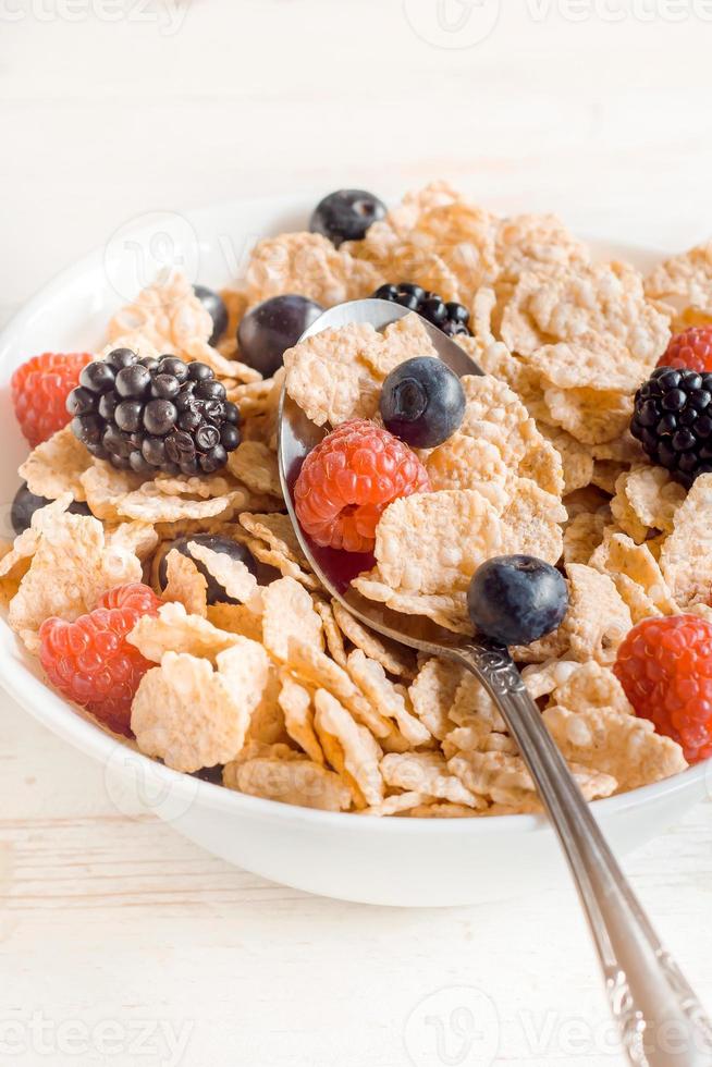 Corn flakes and berry fruits photo