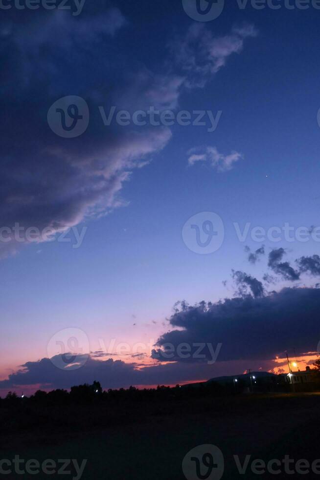 Blue sky with a few clouds in it photo
