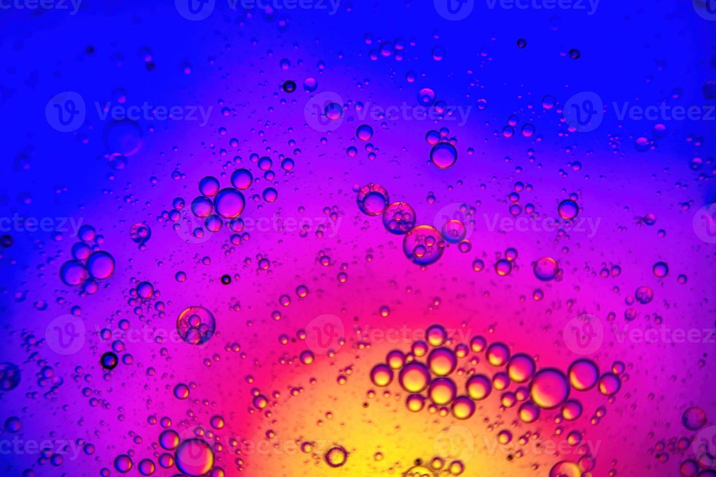 Colorful background with water and oil drops and a yellow and blue background photo