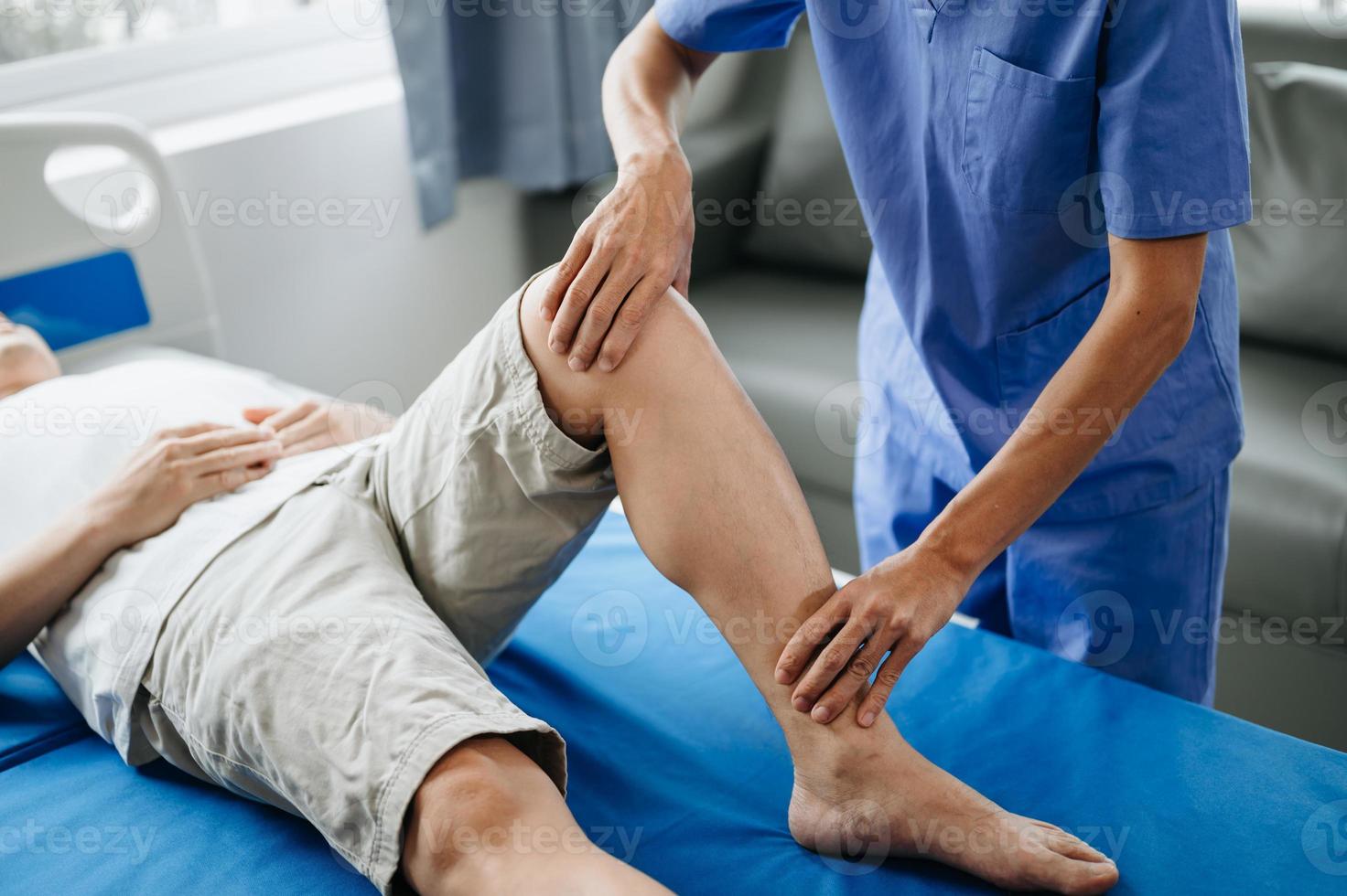 Close up of Physiotherapist working with patient on the bed photo