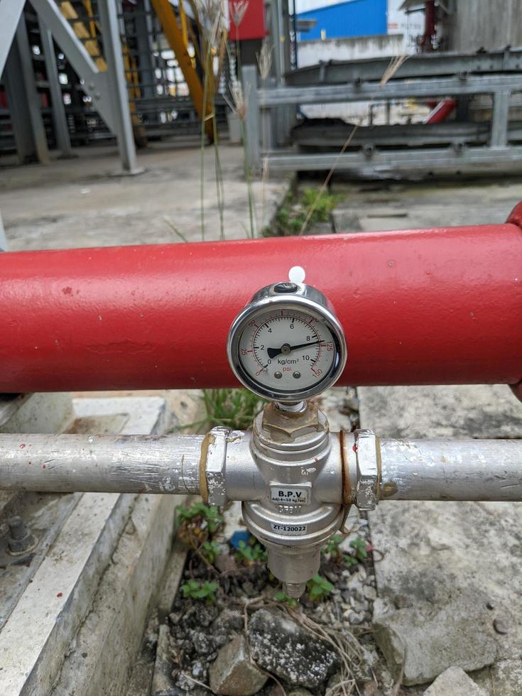 Pressure gauge of pressure sustaining valve for service air on power plant project. The photo is suitable to use for industry background photography, power plant poster and electricity content media.