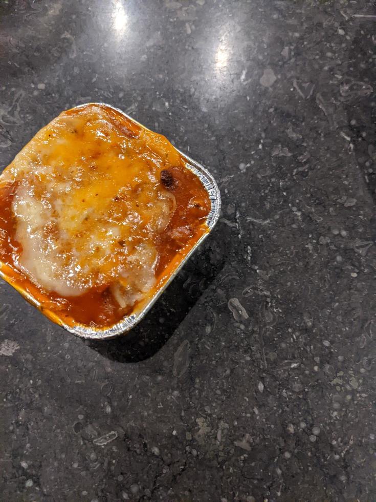 Cedar Cheese and mozzarella on the roasted beef lasagna with chili sauce. The photo is suitable to use for food background, poster and food content media.