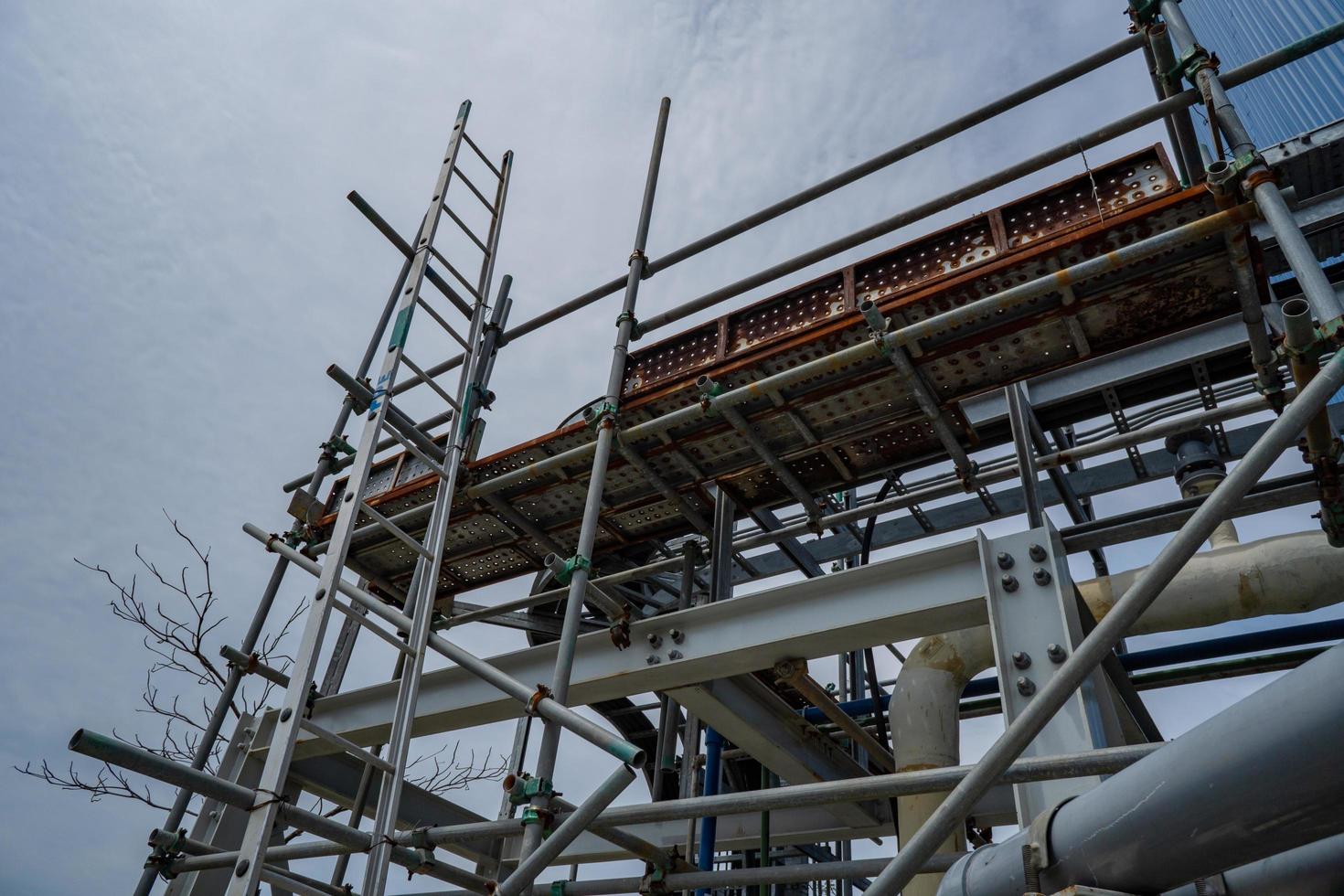 Temporary scafolding on pipe rack, at power plant project. The photo is suitable to use for industry background photography, power plant poster and electricity content media.