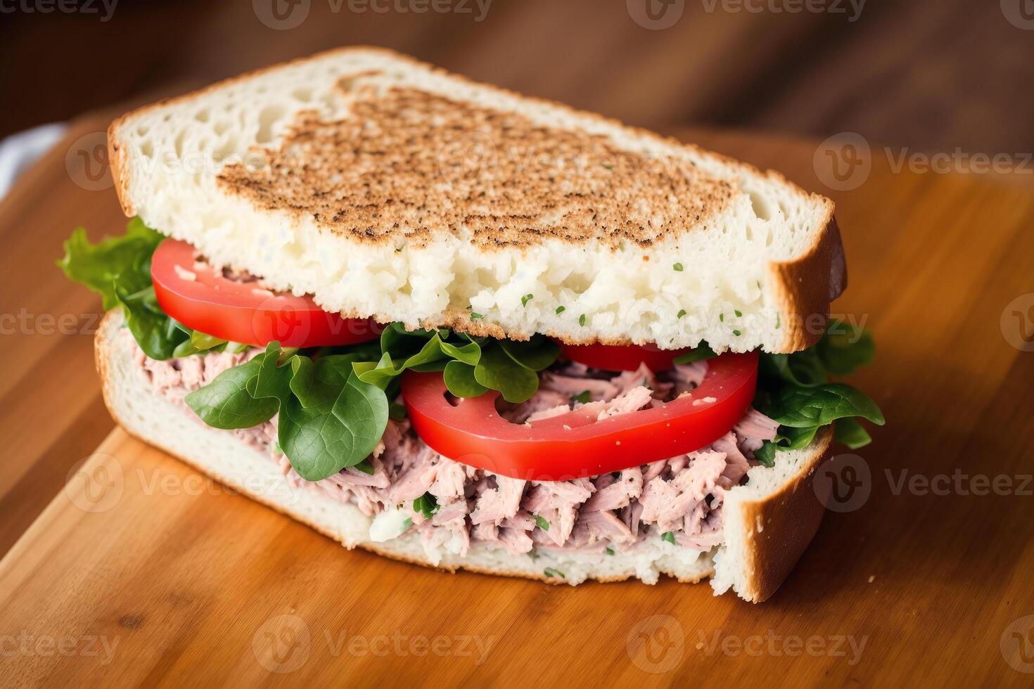 Sandwich with ham, cheese and salad on a white plate. sandwich with tuna and vegetables. photo