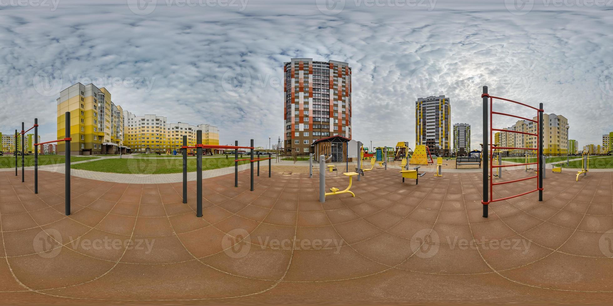 360 hdri panorama view outdoor exercise equipment gym among modern residential complex with skyscrapers and high-rise buildings in equirectangular spherical projection ready VR virtual reality content photo