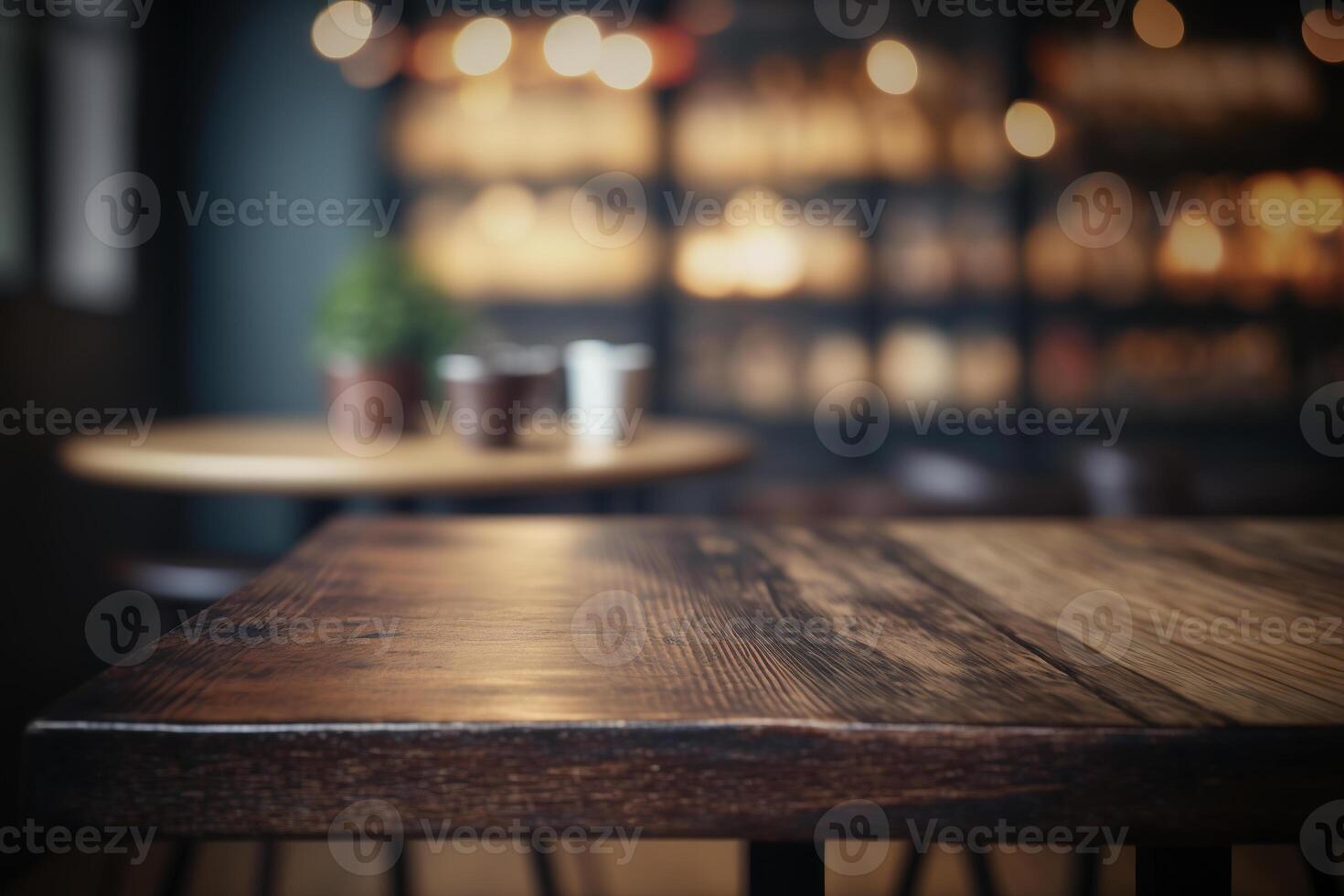 Wooden table in front of abstract blurred coffee shop background. photo