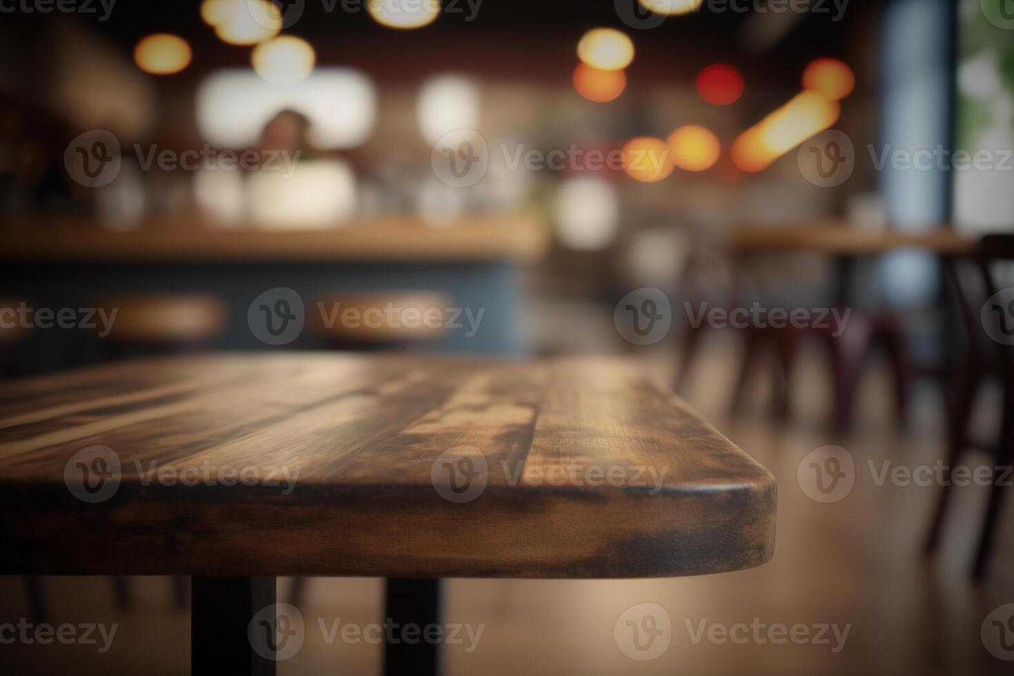Wooden table in front of abstract blurred coffee shop background. photo