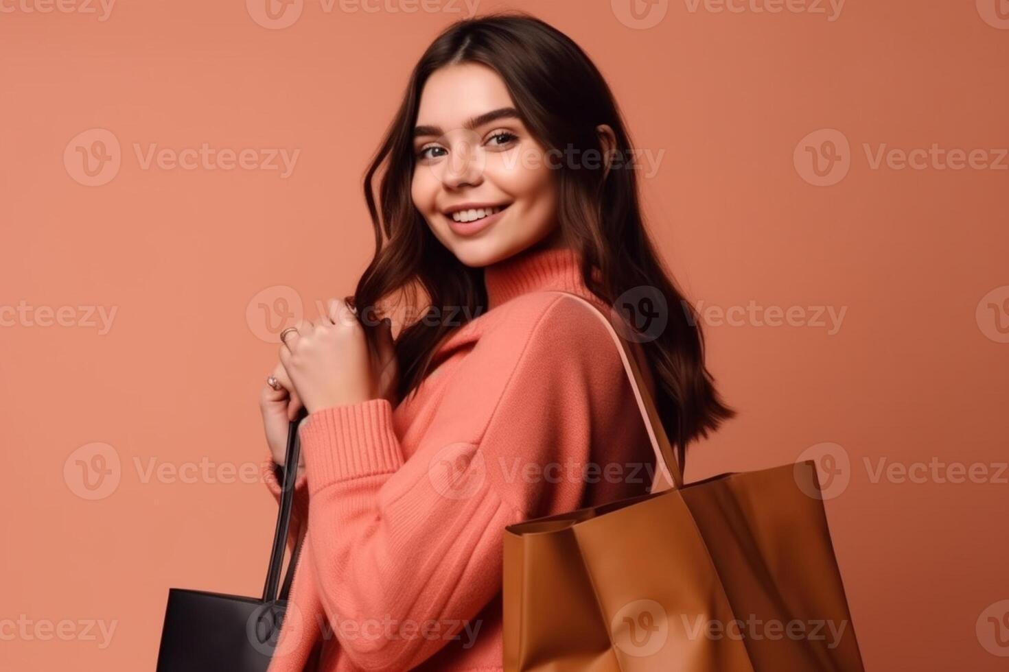 happy young woman in yellow coat holding shopping bags isolated on yellow background photo