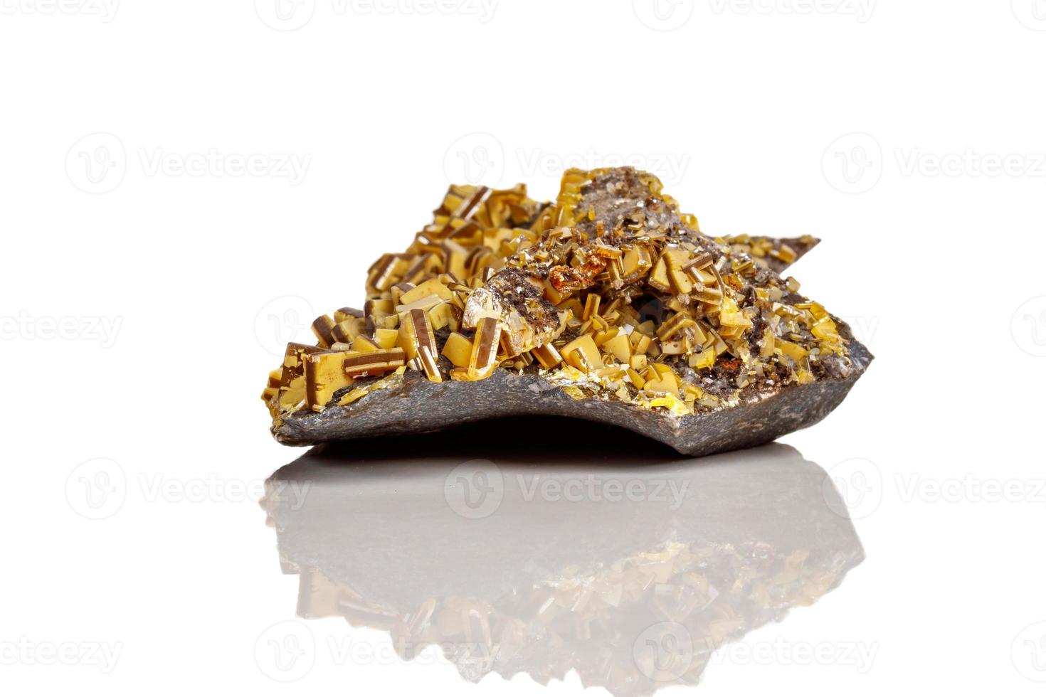 Macro mineral stone yellow Wulfenite on a white background photo