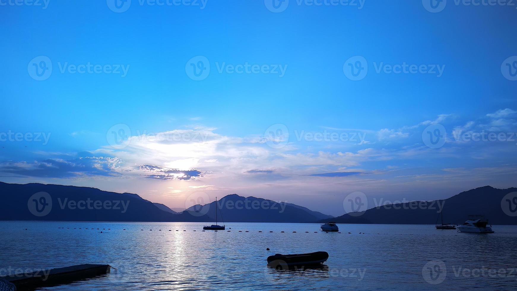 beautiful sunset on the sea and mountains photo