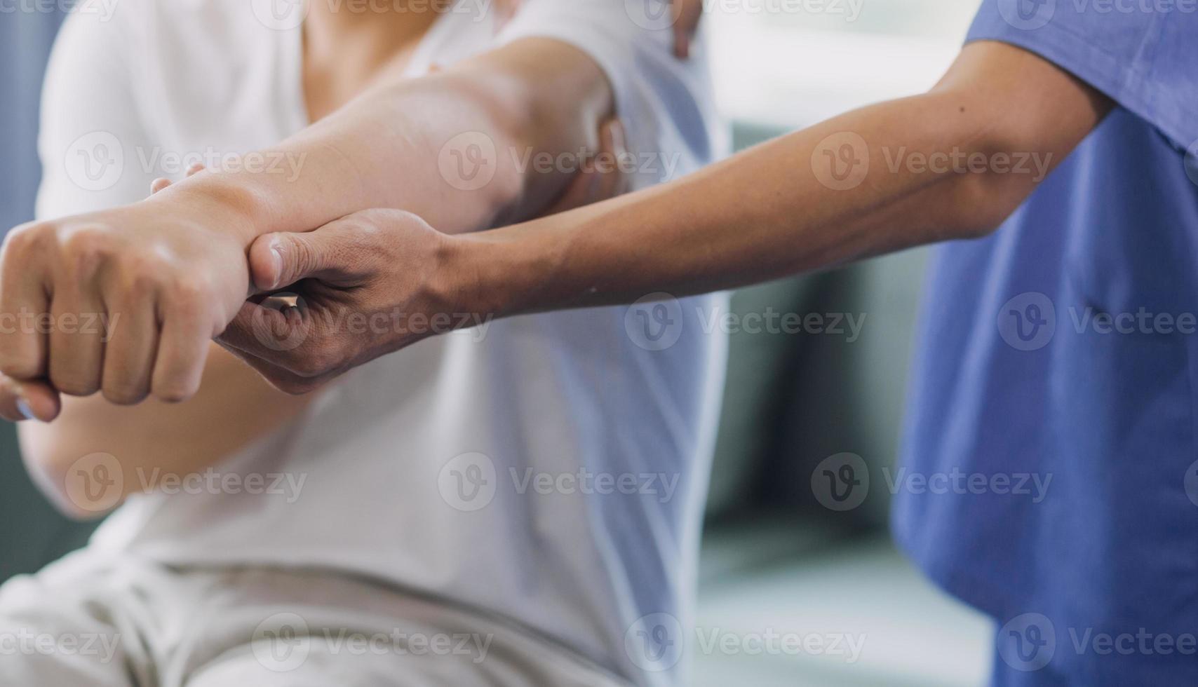 Physiotherapist working with patient in clinic, closeup photo