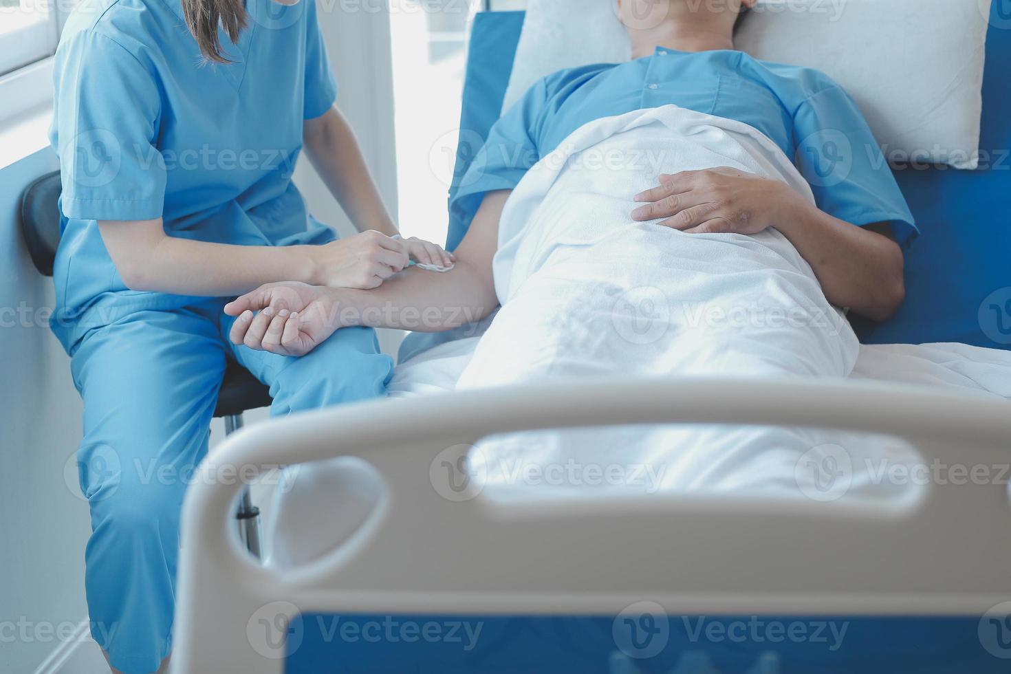 Injured patient showing doctor broken wrist and arm with bandage in hospital office or emergency room. Sprain, stress fracture or repetitive strain injury in hand. Nurse helping customer. First aid. photo