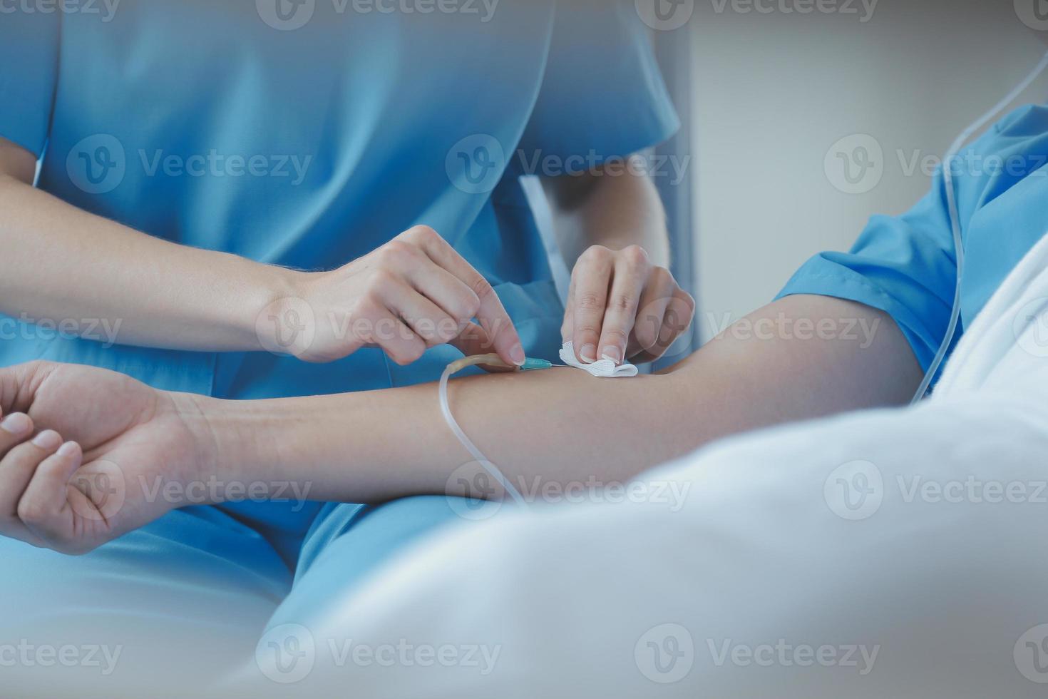 Injured patient showing doctor broken wrist and arm with bandage in hospital office or emergency room. Sprain, stress fracture or repetitive strain injury in hand. Nurse helping customer. First aid. photo