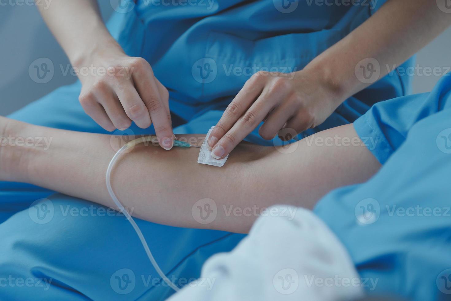 Injured patient showing doctor broken wrist and arm with bandage in hospital office or emergency room. Sprain, stress fracture or repetitive strain injury in hand. Nurse helping customer. First aid. photo