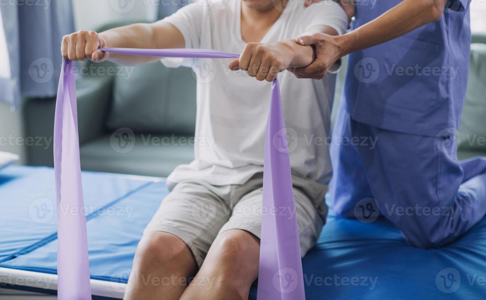 Physiotherapist working with patient in clinic, closeup photo