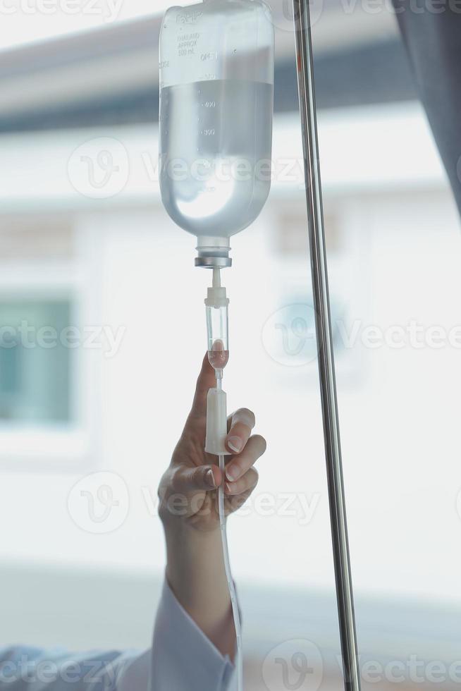 Injured patient showing doctor broken wrist and arm with bandage in hospital office or emergency room. Sprain, stress fracture or repetitive strain injury in hand. Nurse helping customer. First aid. photo