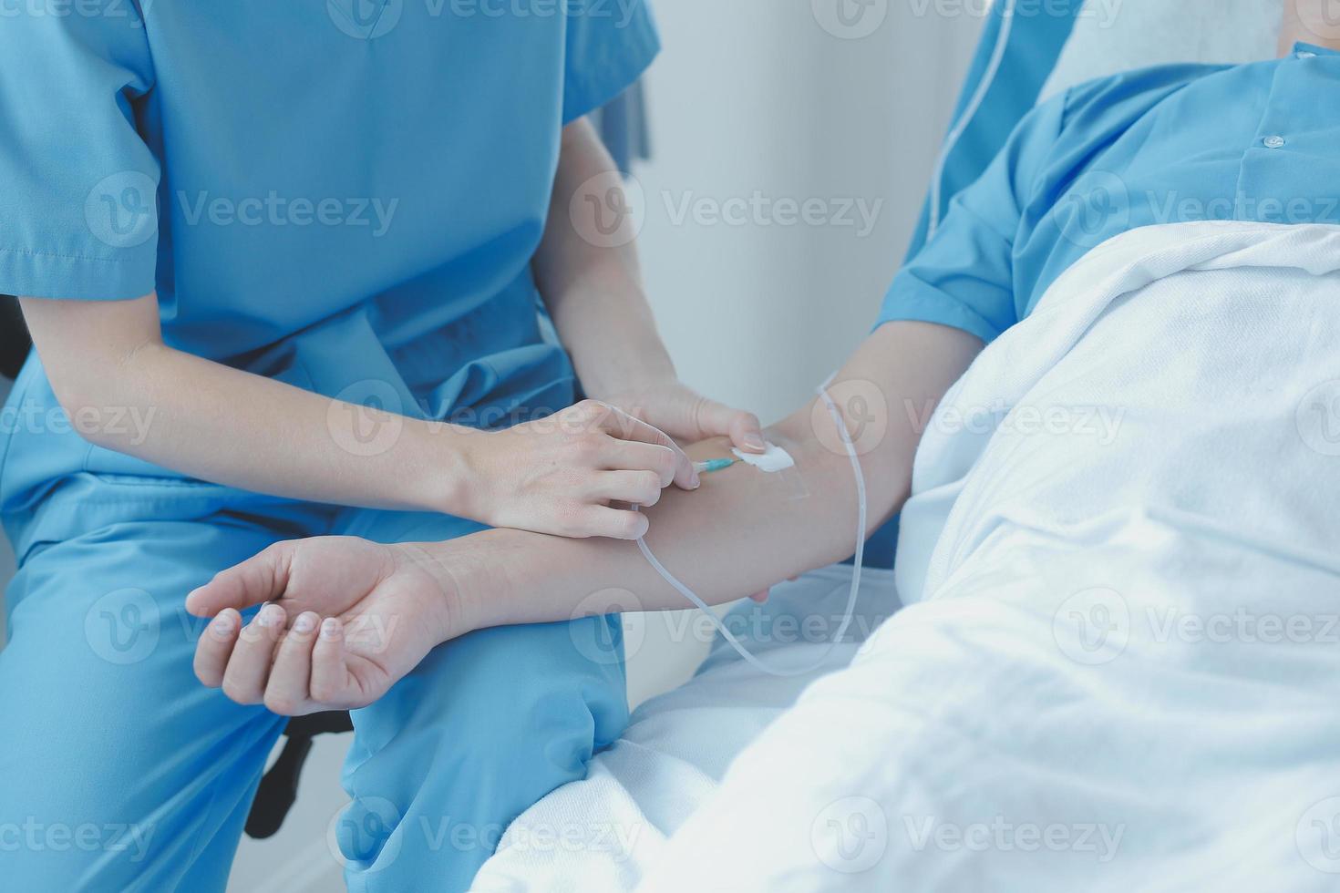 Injured patient showing doctor broken wrist and arm with bandage in hospital office or emergency room. Sprain, stress fracture or repetitive strain injury in hand. Nurse helping customer. First aid. photo