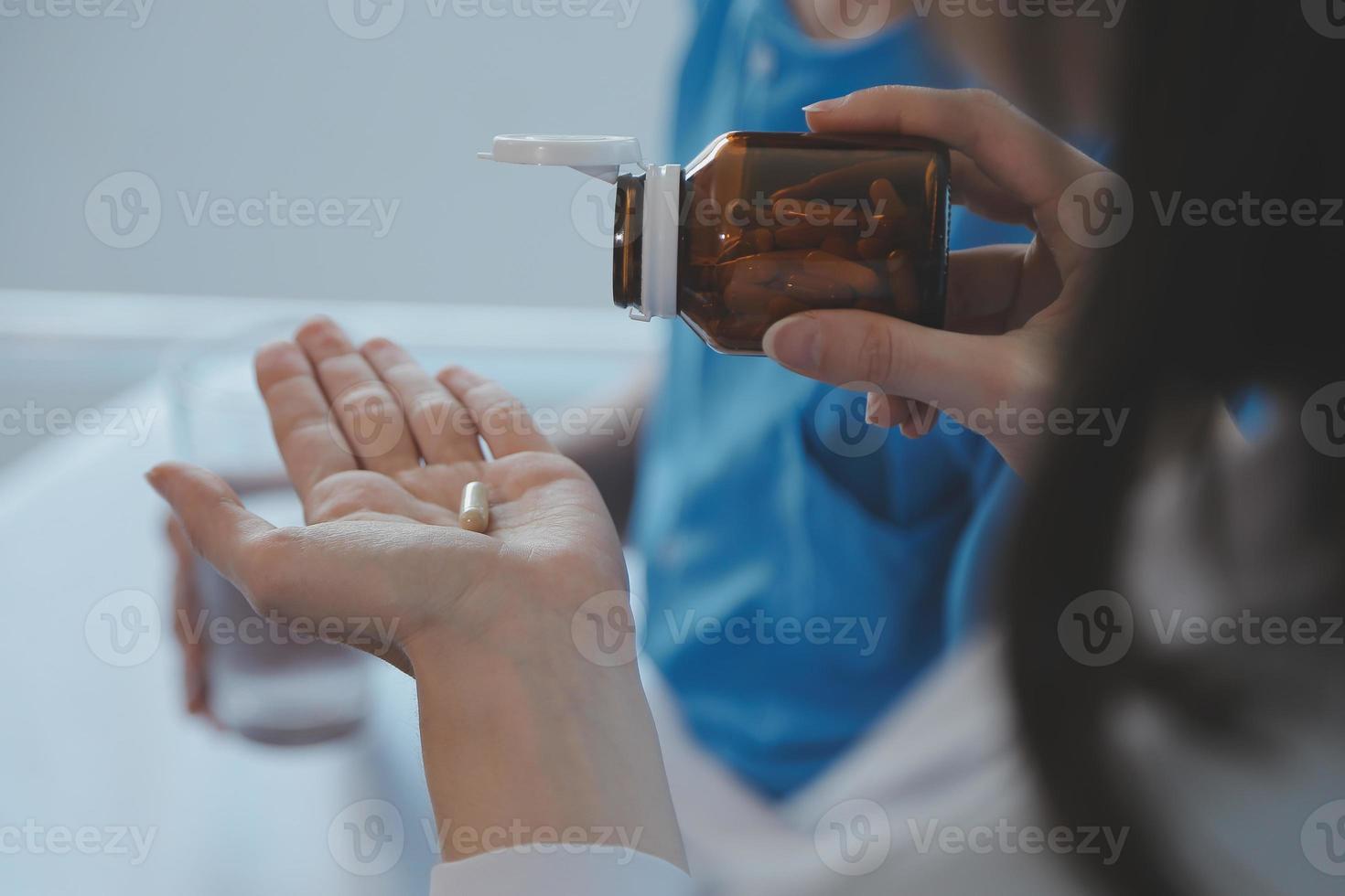 Injured patient showing doctor broken wrist and arm with bandage in hospital office or emergency room. Sprain, stress fracture or repetitive strain injury in hand. Nurse helping customer. First aid. photo