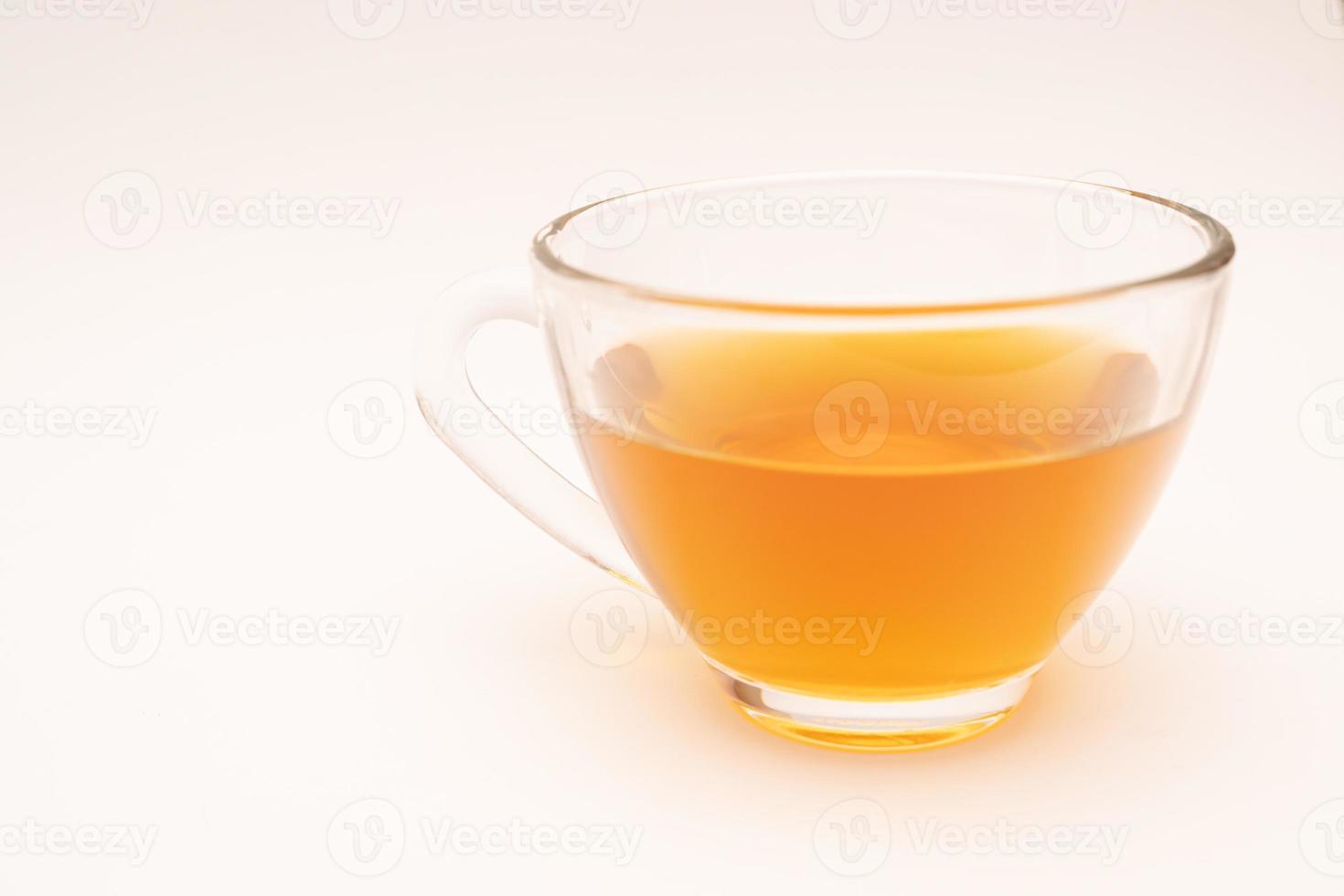 Glass cup of hot ginger tea isolated on white background. photo