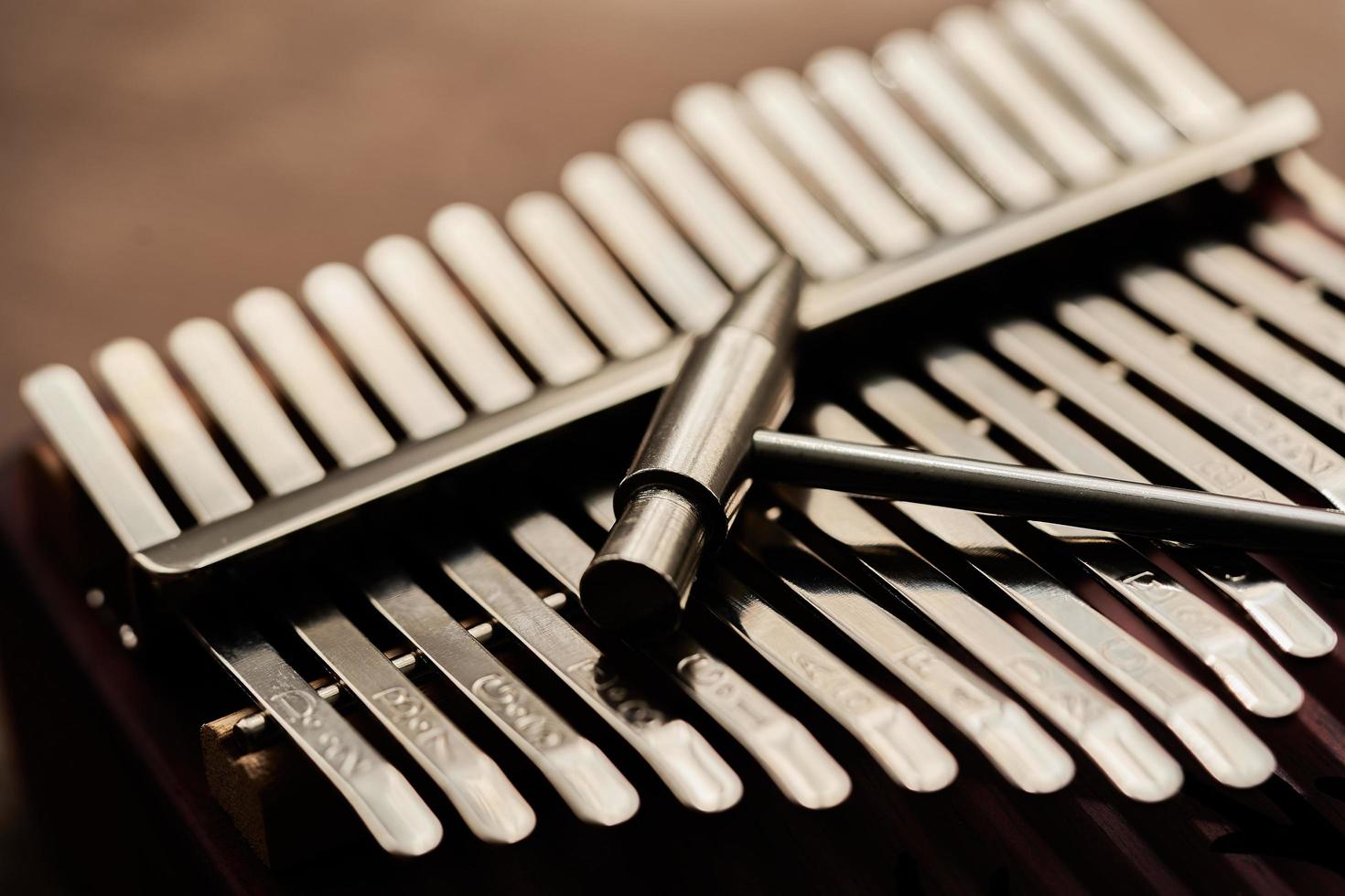 close up concept Kalimba mineral steel key or metal strip with Kalimba Tuning Hammer background photo