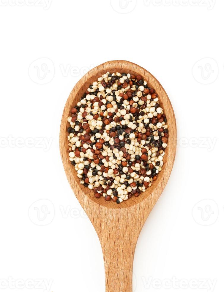 top view or flat lay quinoa seeds in wooden spoon isolated on white background. close up quinoa seeds in wooden spoon isolated on white background. quinoa seeds in spoon isolated photo