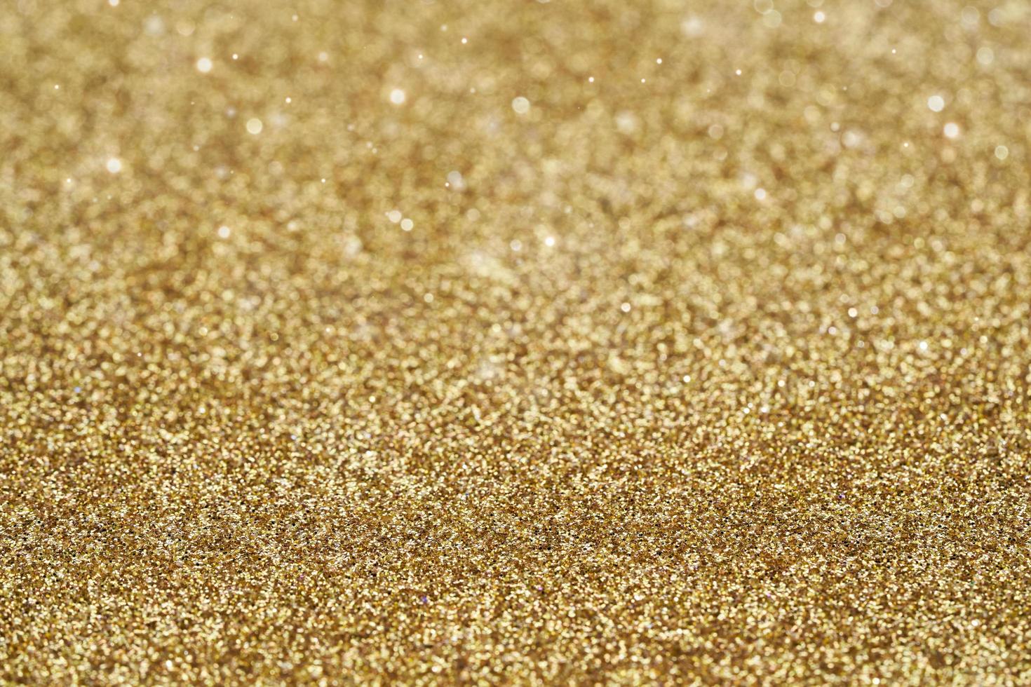 gold golden dust spark glitter texture christmas abstract sparkle background. close up gold golden dust spark glitter texture christmas abstract sparkle background. gold golden bokeh glitter photo