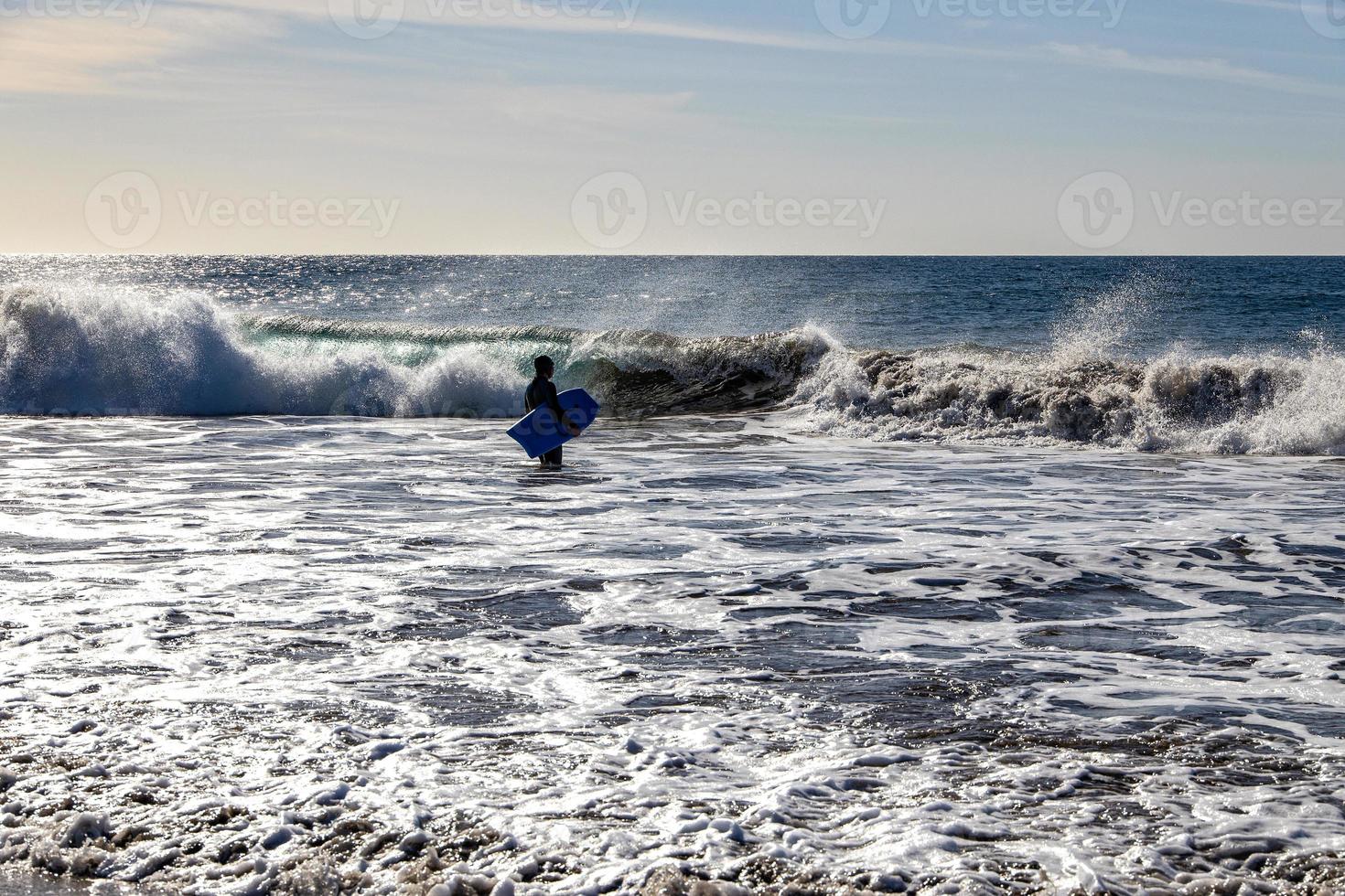 surfer on a background of rough oceans on a warm sunny summer  day, photo