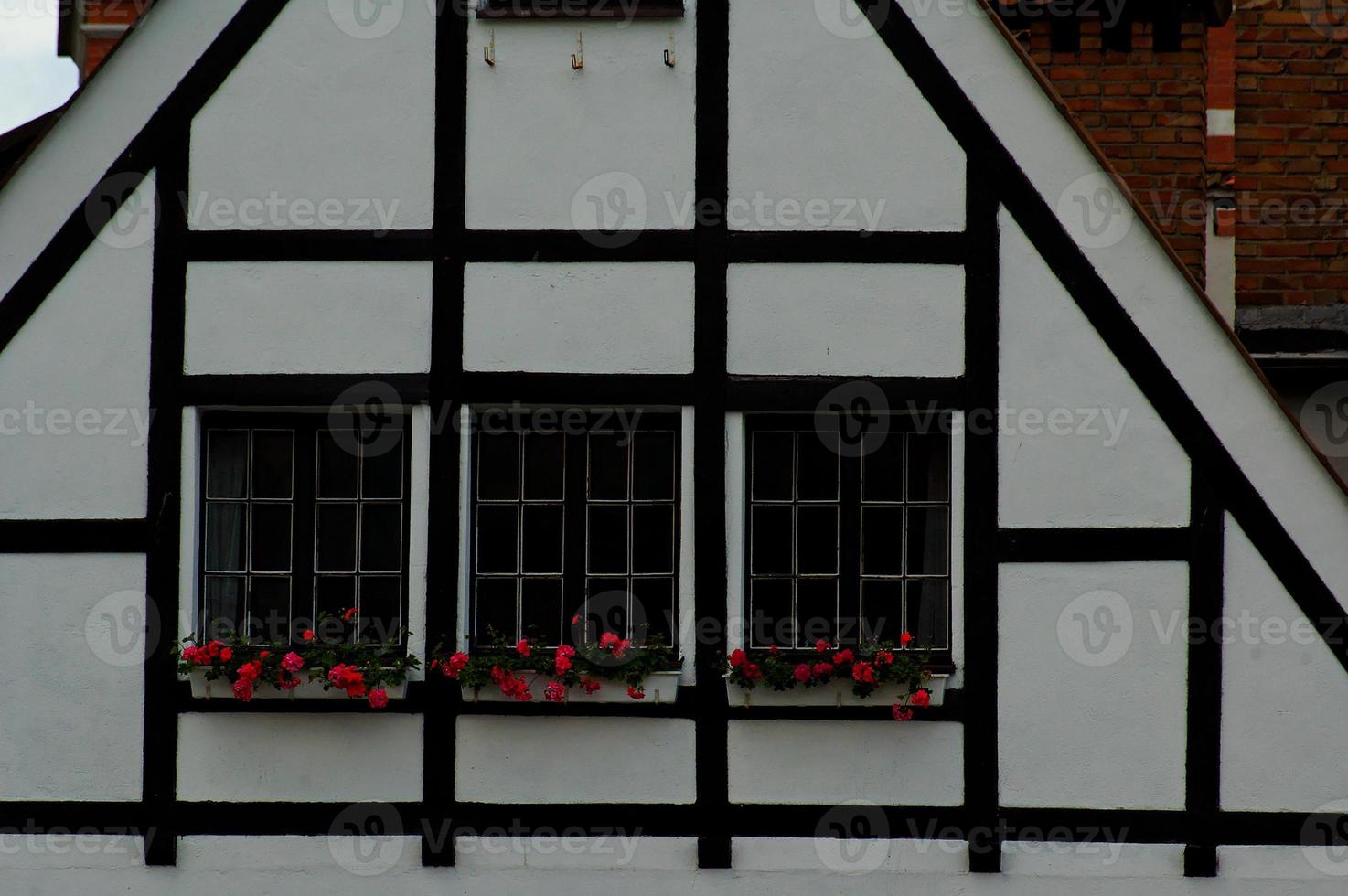 interesting windows in old historic tenement houses in the Polish city of Gdansk close up photo