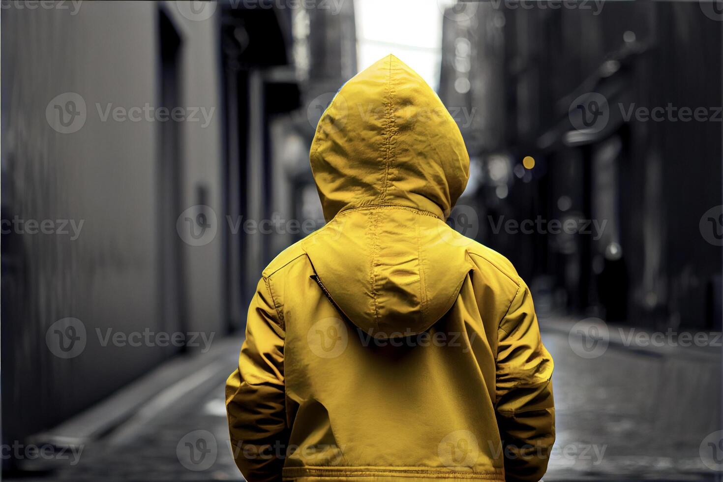 person in a yellow jacket walking down a street. . photo