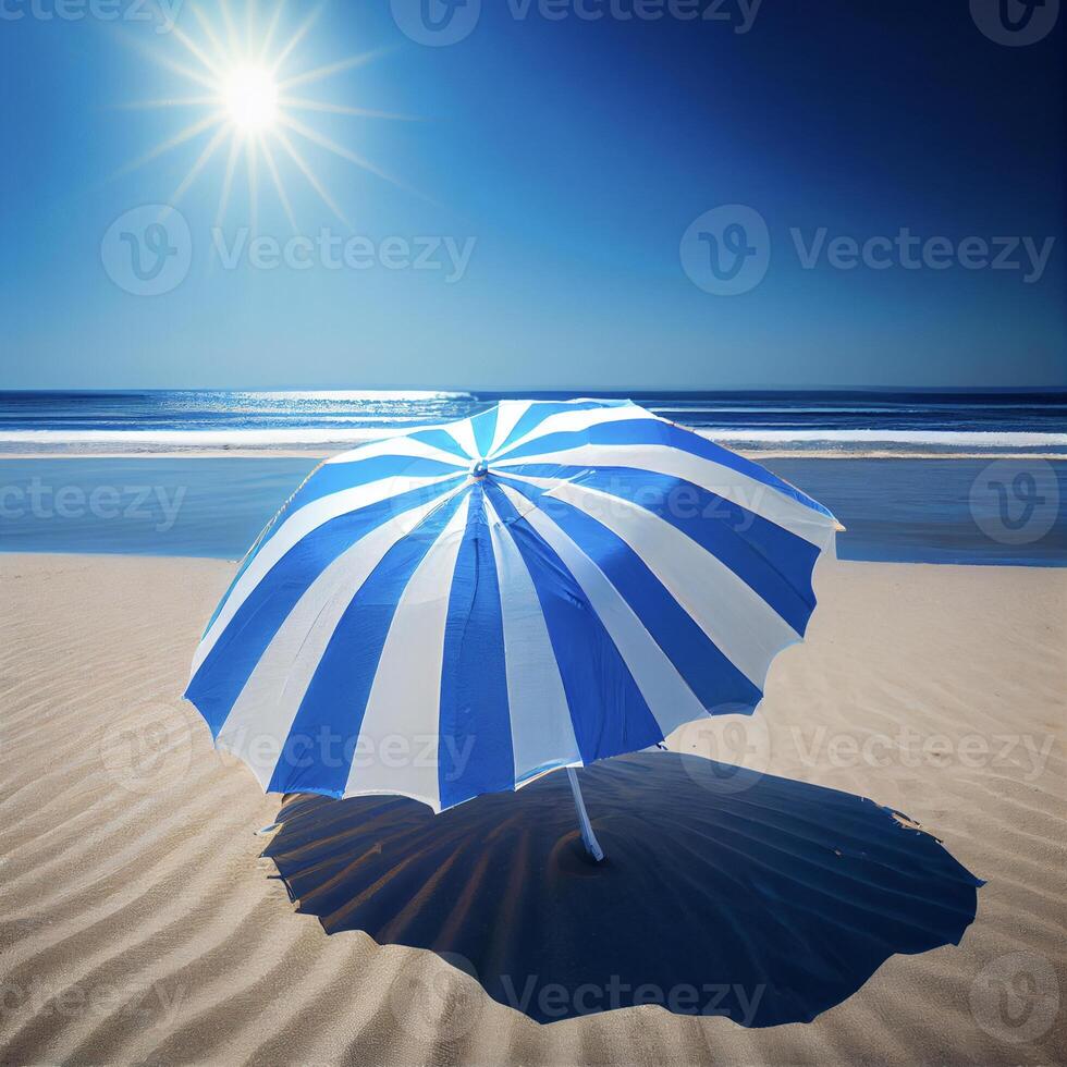 blue and white umbrella sitting on top of a sandy beach. . photo