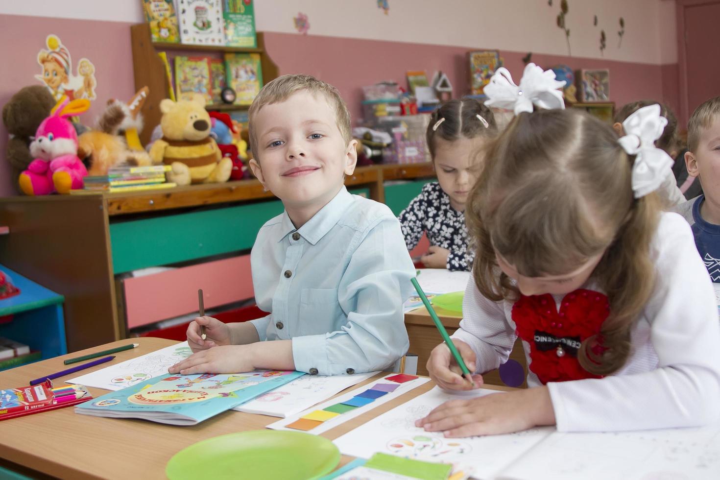 . niños preescolares dibujar en jardín de infancia. foto