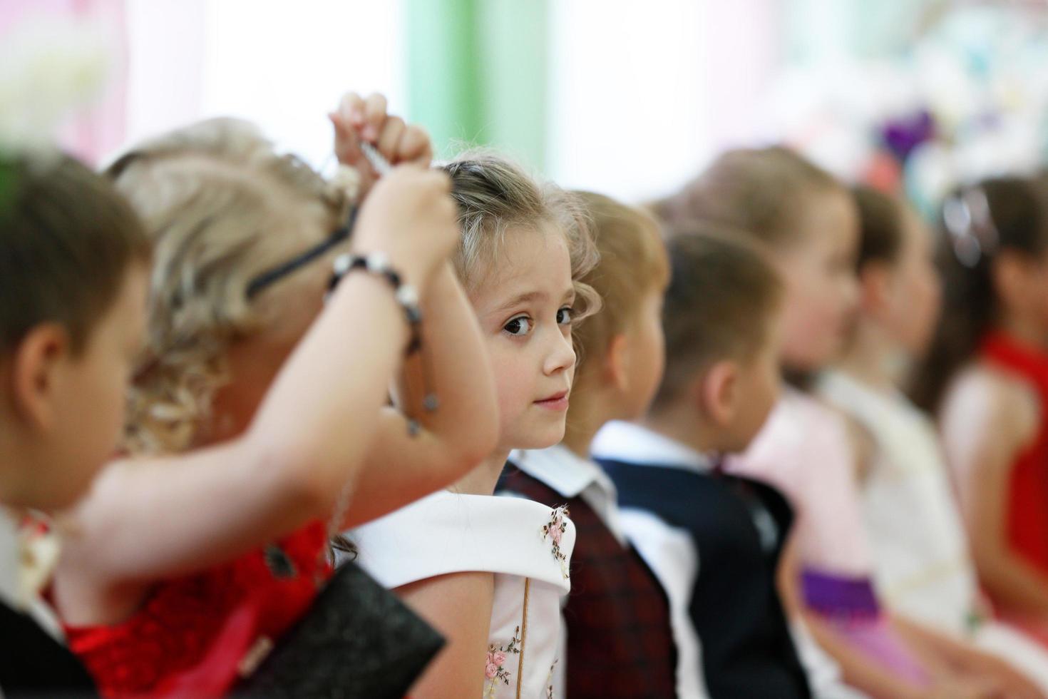 Child preschooler in the ranks of children. photo