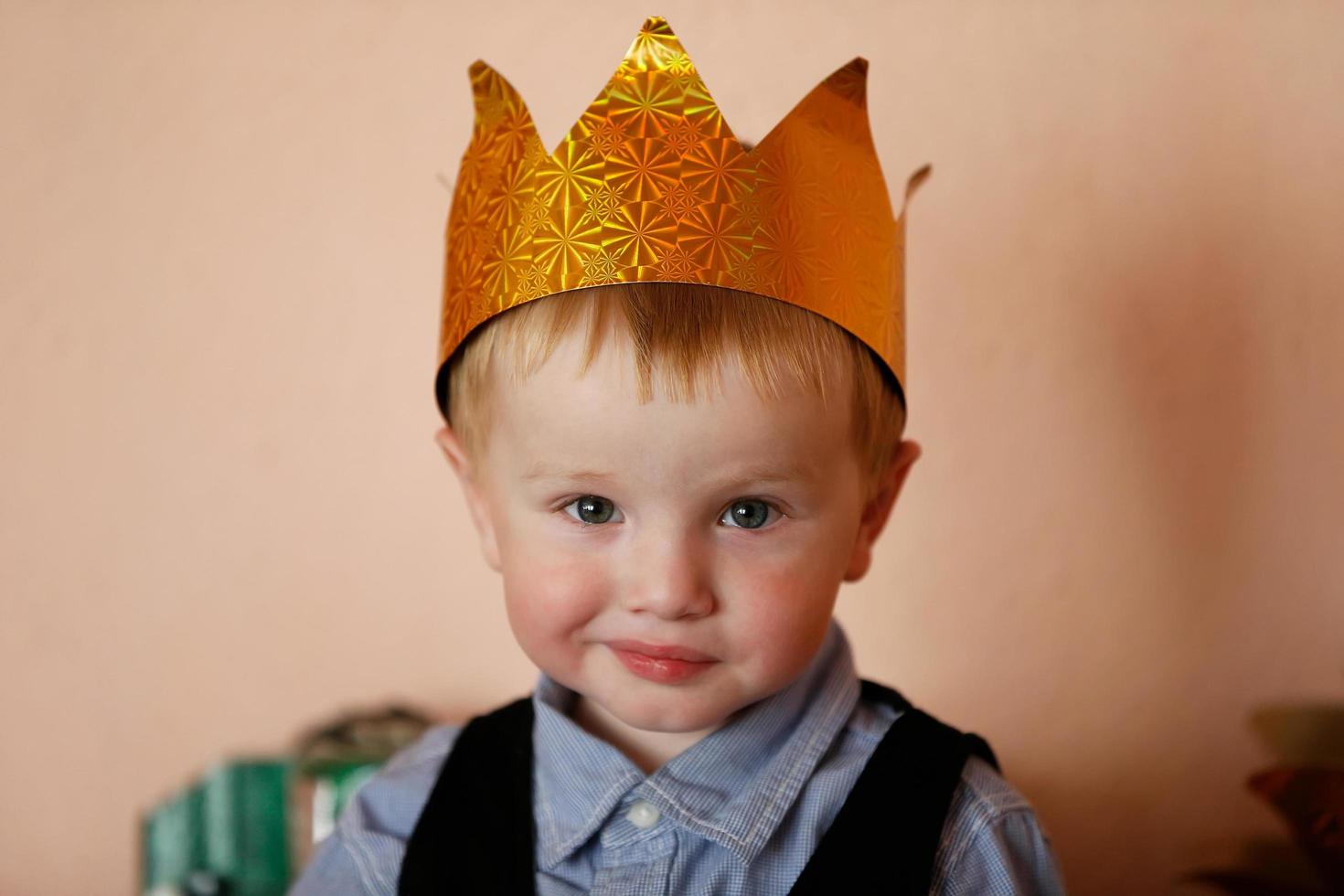 Funny little boy in the crown. photo