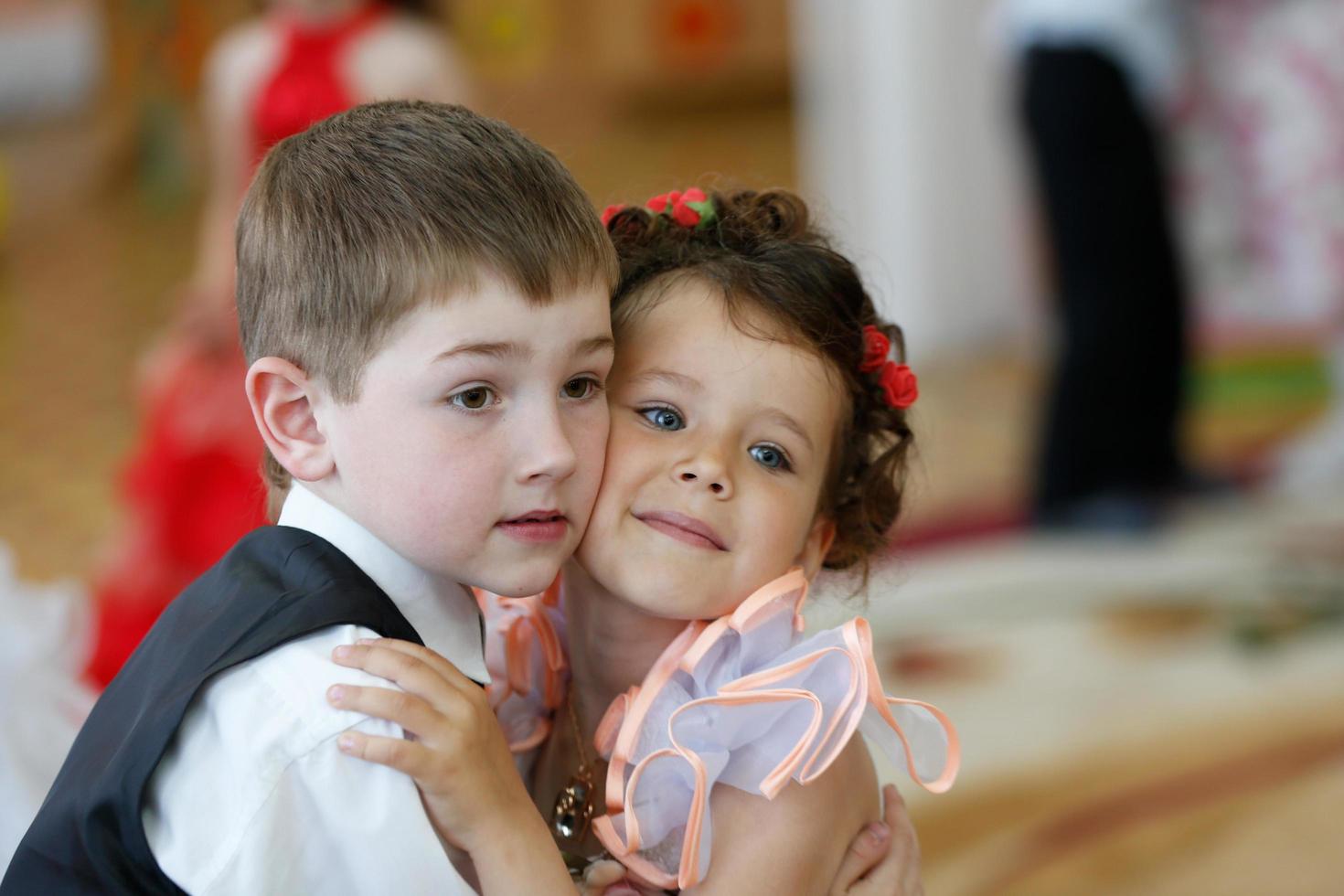Beautiful children are preschoolers dancing. Boys and a young girl head to head. photo