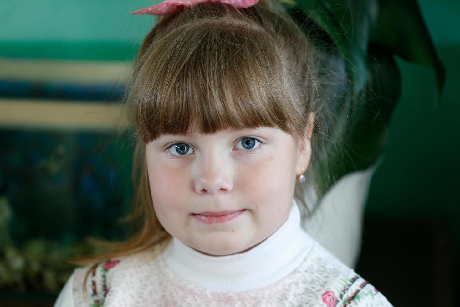 Photo session in kindergarten.Portrait of a preschool girl.