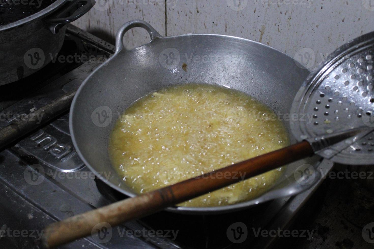 the pan is frying the potatoes on the stove photo