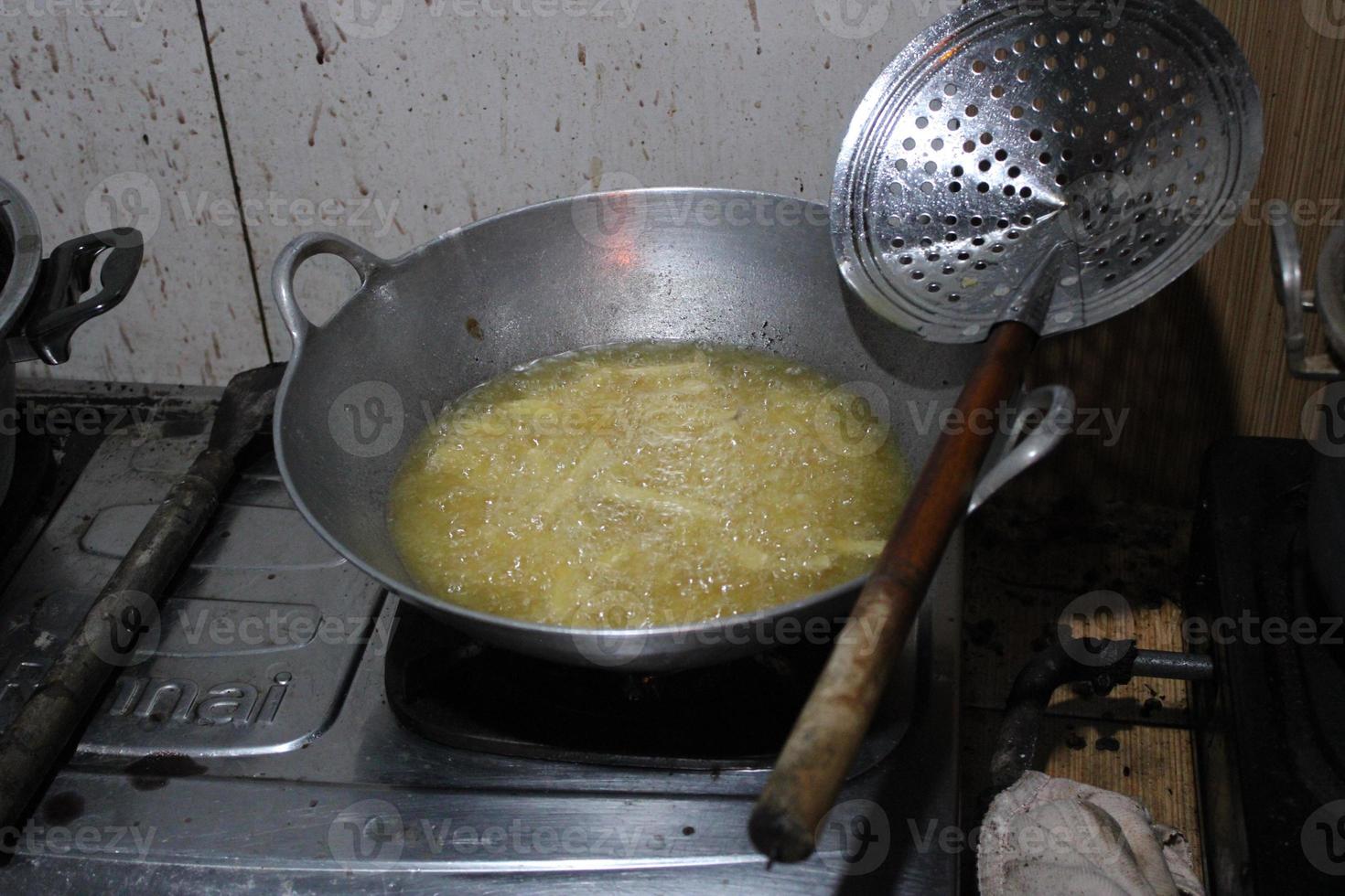 the pan is frying the potatoes on the stove photo