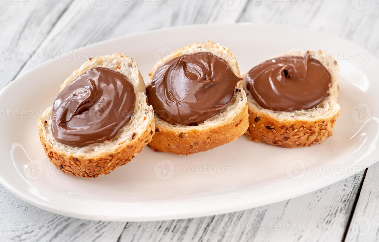 Slices of baguette with chocolate paste photo