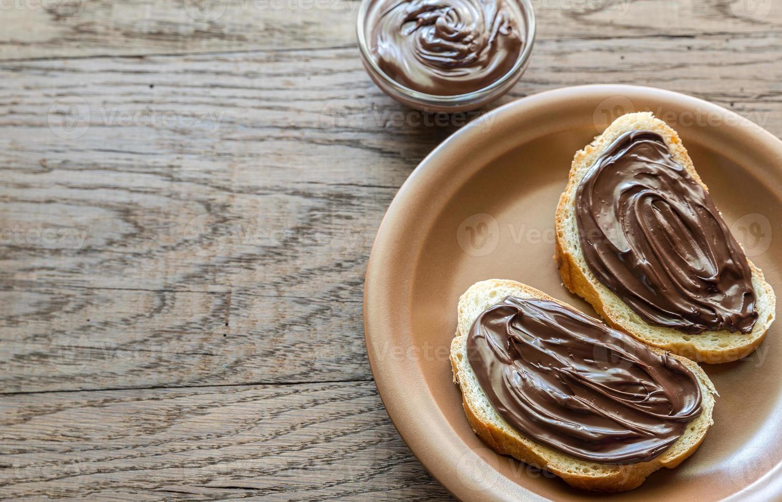 Slices of baguette with chocolate cream photo