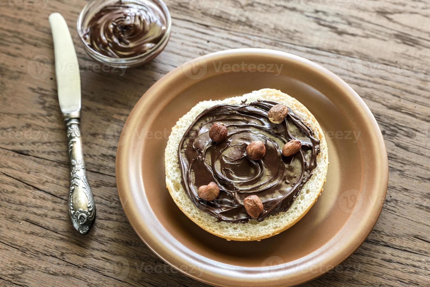 Seasame bun with chocolate cream and nuts photo