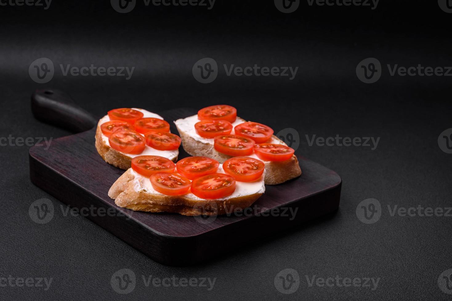 Delicious crispy grilled toast with cheese and cherry tomatoes photo