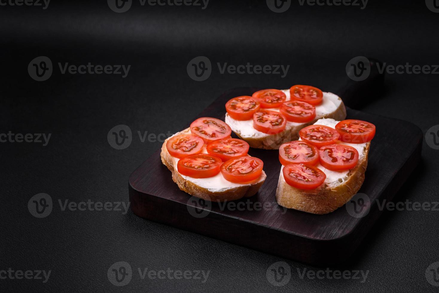 Delicious crispy grilled toast with cheese and cherry tomatoes photo