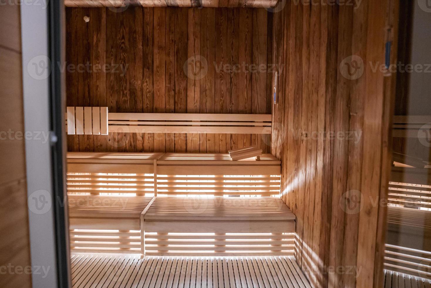 Interior of sauna with wooden wall and bench in modern hotel photo