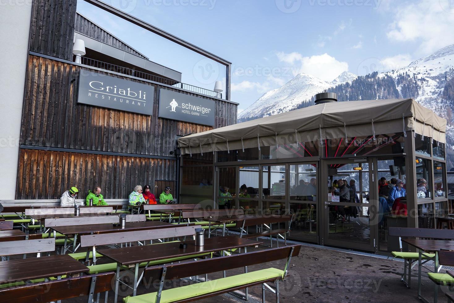 Tourists at restaurant in front of sky during winter vacation photo