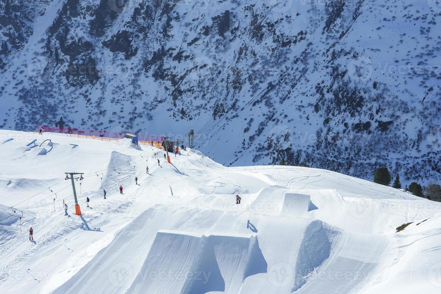 Tourists skiing on snow mountain during vacation photo