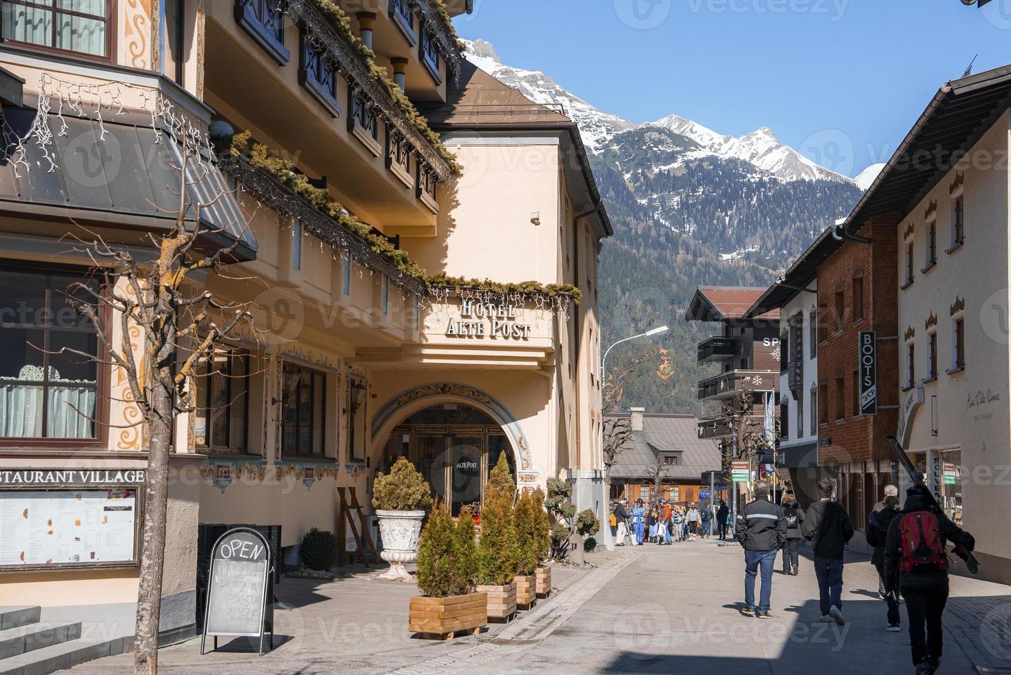 Tourists on street amidst buildings during winter vacation photo