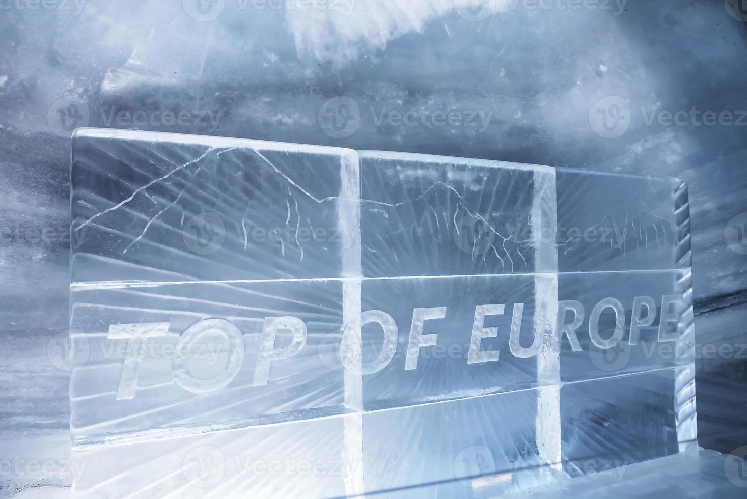 Jungfrau ice palace with top of europe text on frame in glacier tunnel photo