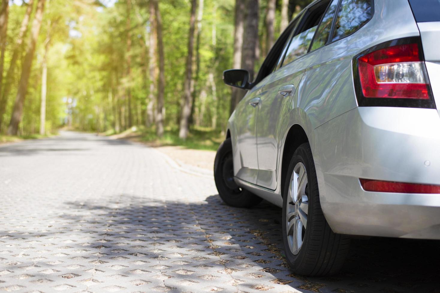 Gray car in the forest with an open door. Car on the road. photo