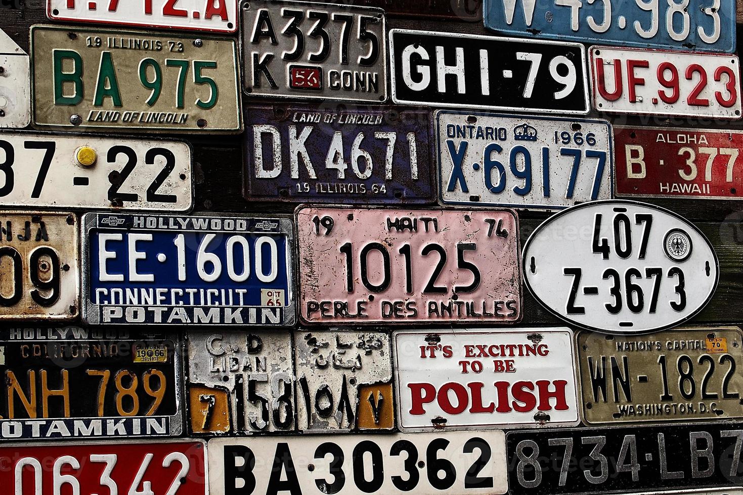 Various old car license plates from around the world at the museum photo